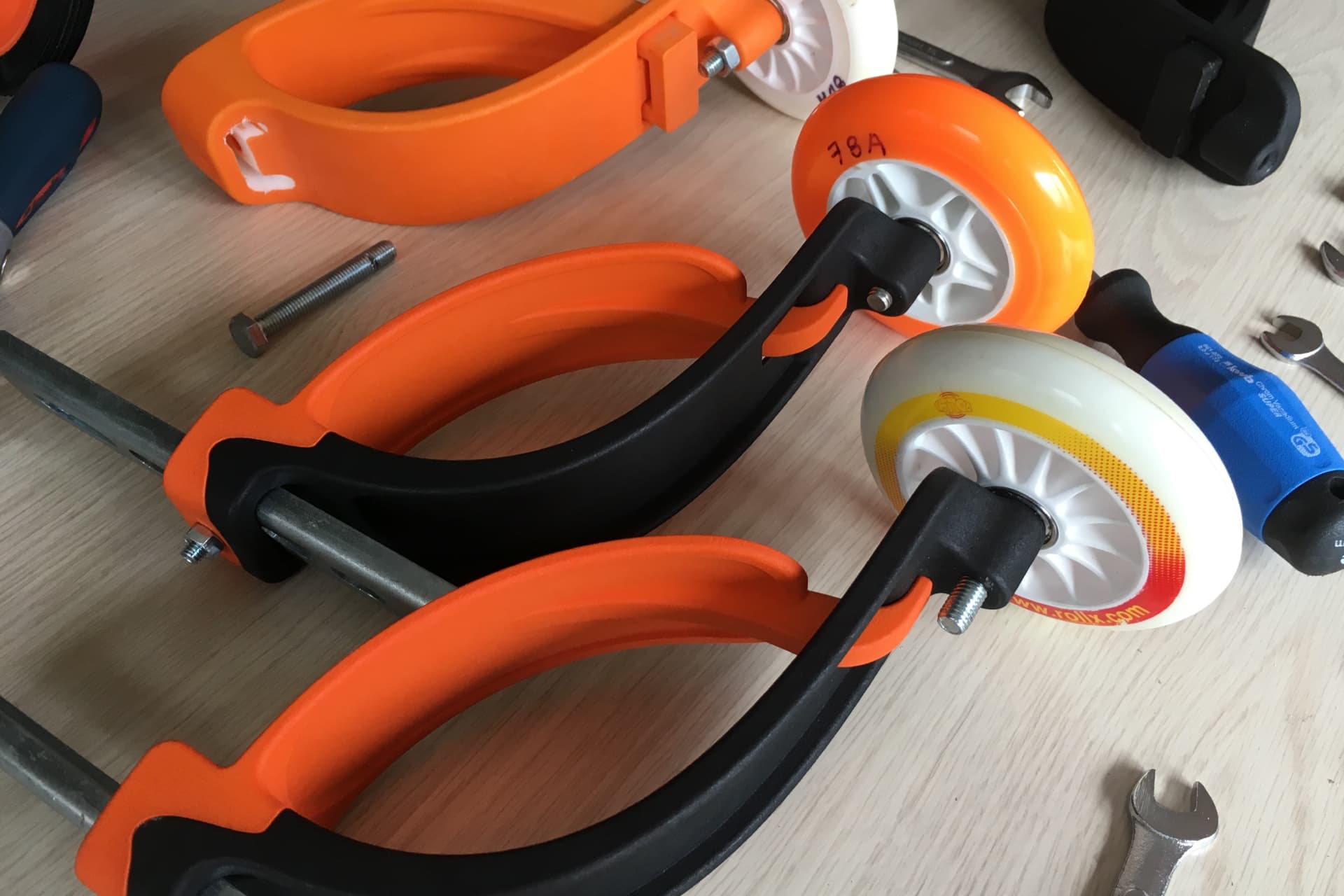 Baswil prototypes on the workbench — orange and black, different versions